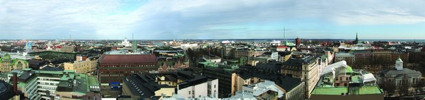 Click on picture - Helsinki skyline towards north and east. To the left of centr the green dome at the white Helsinki cathedral on the Senate square. Photo: Odd Iglebaek