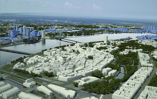 Model of Riga, the white areas are existing buildings while the light blue areas denote potential new developments. The white buildings in the foreground bordered by green areas highlight the ‘old town’. On the other side of the river the light blue buildings indicate where, and  to what extent, high-rise development can take place. The white tower on the the far side riverbank is the new Swedbank headquaters. Photo of model provided by the City of Riga.